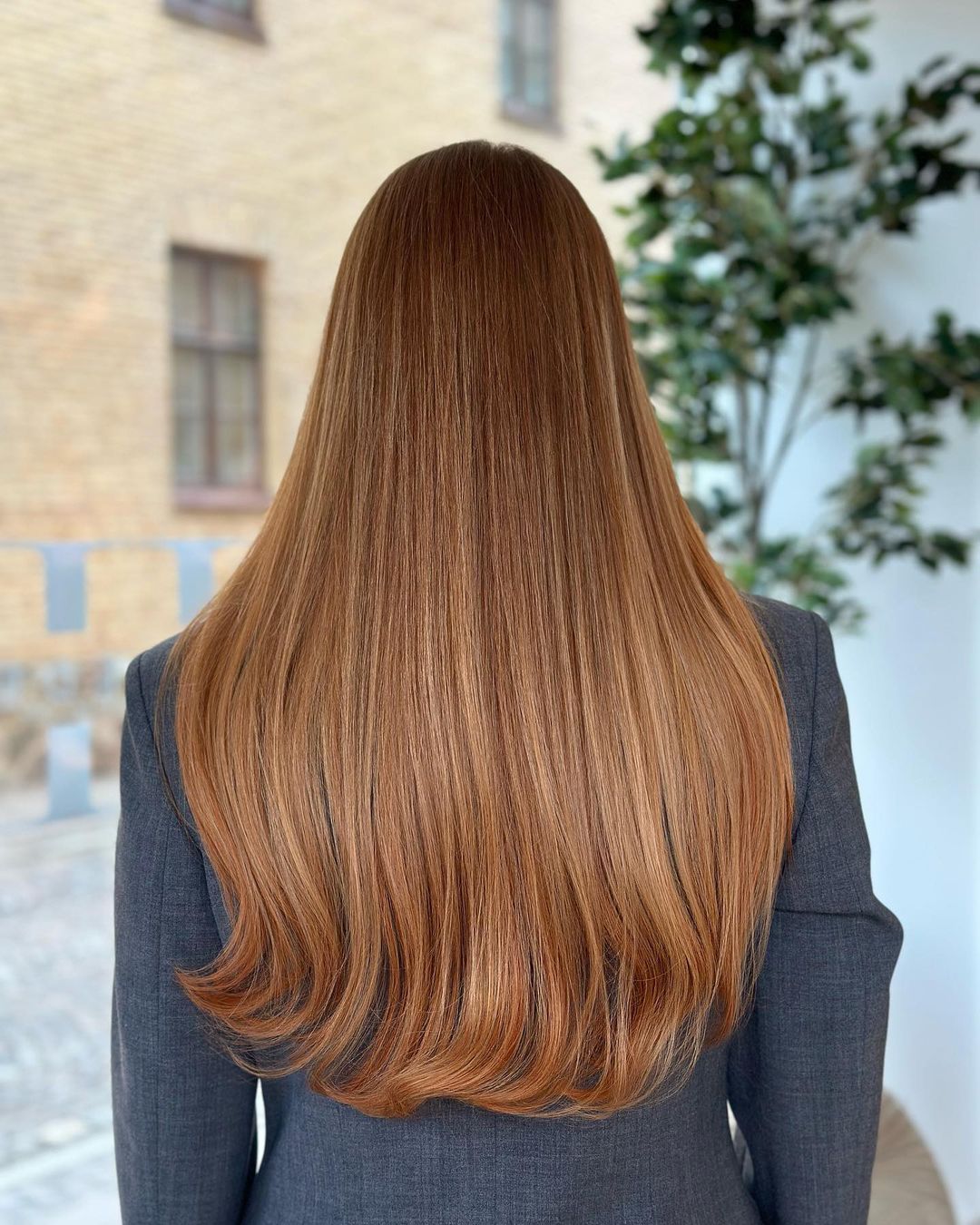 Brown-haired woman with 50cm long BHBD hair extensions. 