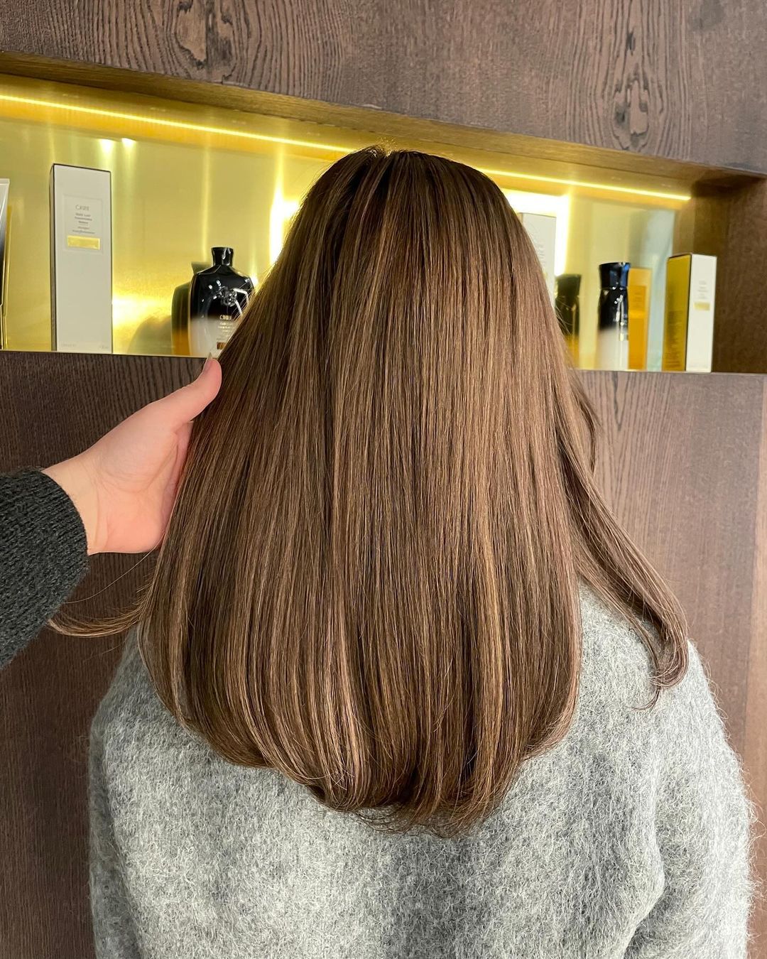 Brown-haired woman with 35cm long BHBD hair extensions.