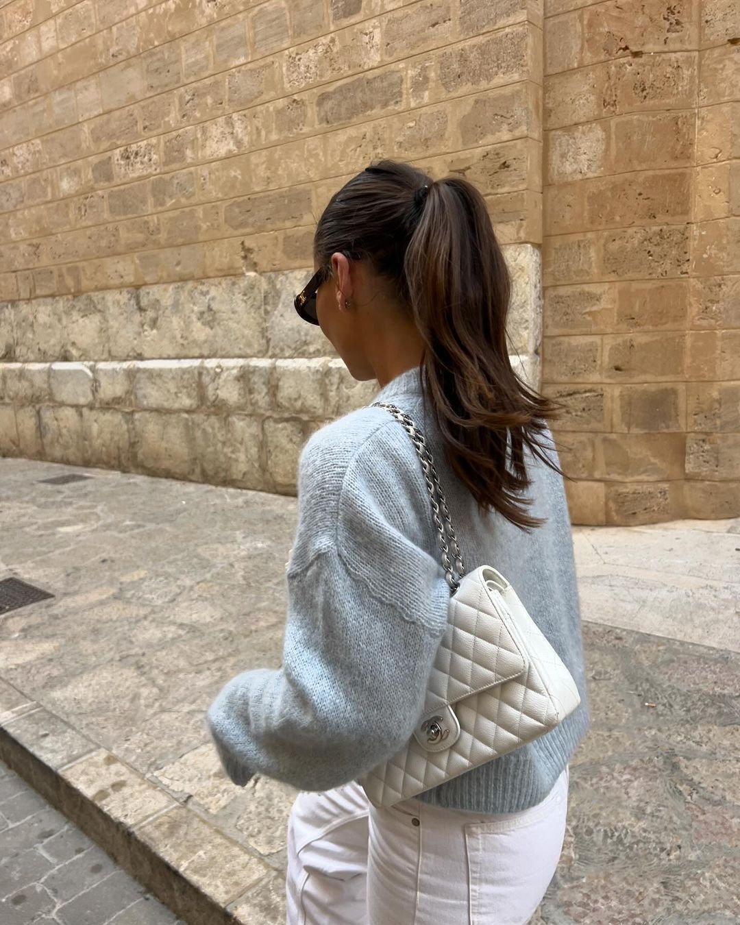 Woman with long dark brown ponytail created with BHBD hair extensions. 